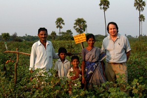 With Yaku and family. Yaku had us stand where viewers could see three elememnts of organic farming: a bird perch, pheromone trap, and marigolds. Andhra Pradesh, 2005. 